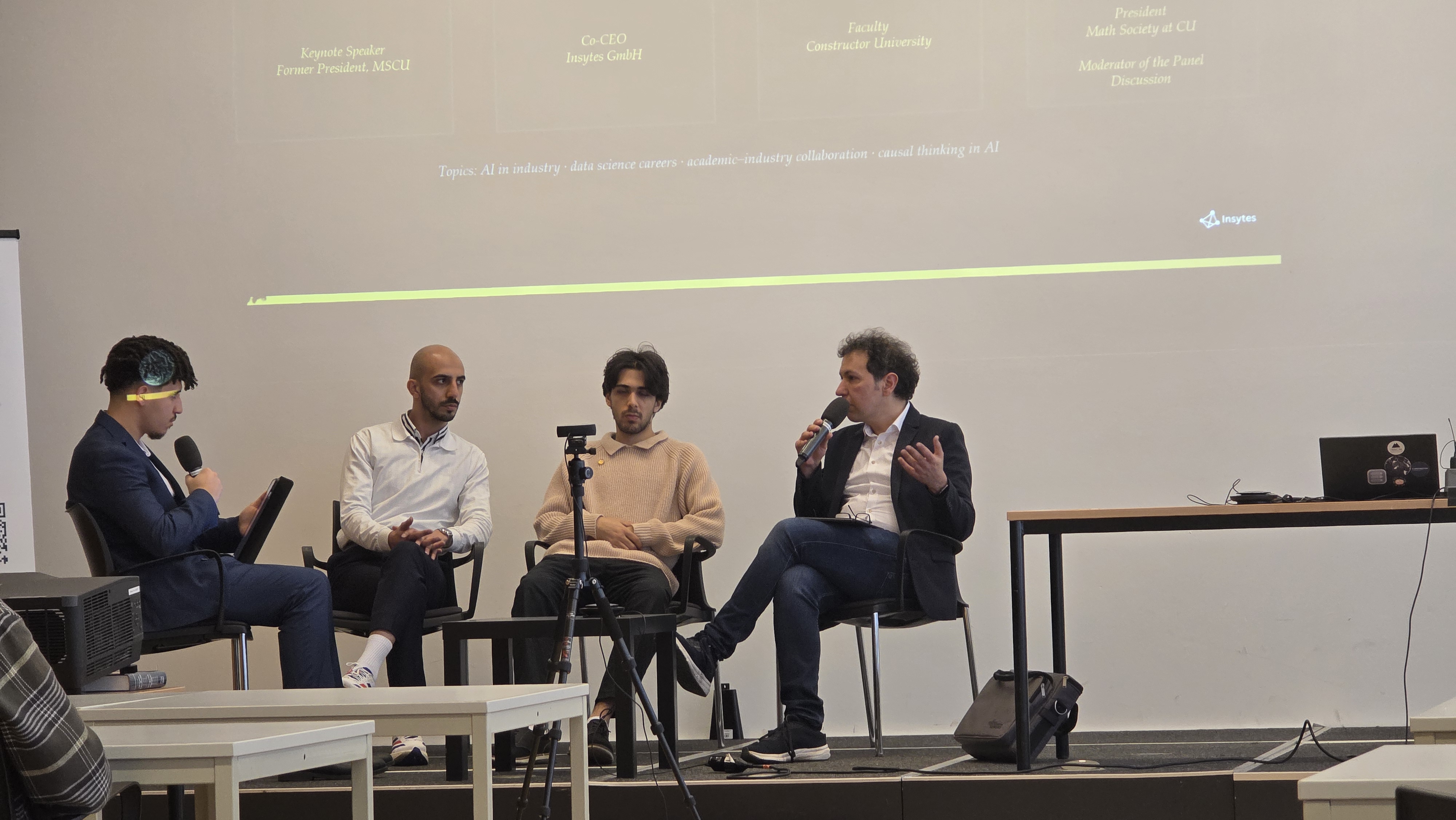 From Proof to Product panel — Ahmed Maghri, Karim Abualrish, Omar Elshinawy, and Prof. Keivan Mallahi-Karai in discussion